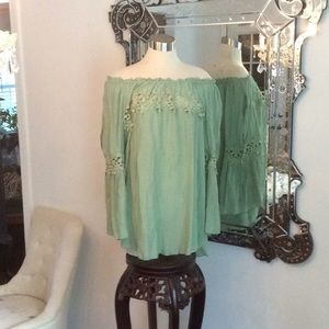 New.  Pretty flowing embroidered women’s top.